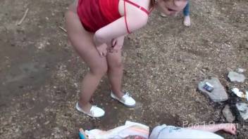 Quartet of females defecate into a grown man's mouth outdoors