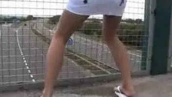 Blonde in miniskirt pissing on the bridge